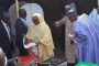 President Buhari Stares Curiously at Wife's Ballot Paper